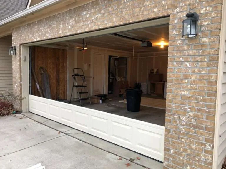 Garage door installation process, bottom panel installed